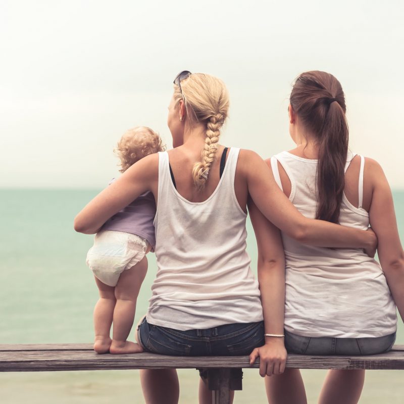 Loving mother embracing her children looking into the distance